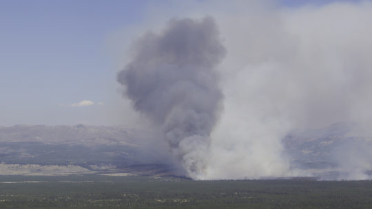 A Giant Plume Of Smoke Is Seen On The Yellowstone National Park Landscape As The Maple Fire Burns